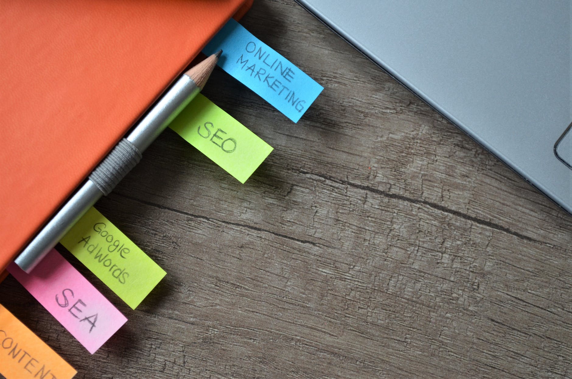 close up of sticky notes and pencil on notebook